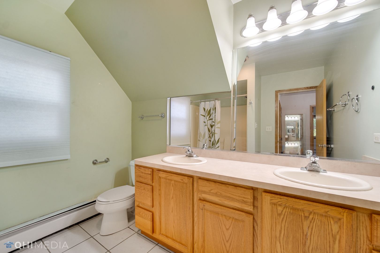 18104 Park Avenue Homewood, IL 60430 - Photo 18 of 26 a bathroom with a sink a toilet and a mirror