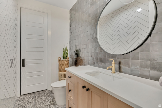 1720 Hillcrest Circle Mapleton, UT 84664 - Photo 50 of 116 Bathroom featuring tile walls, dark speckled floor, vanity, and backsplash