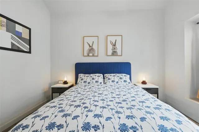 a bedroom with a large bed and a lamp