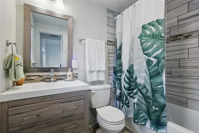 a bathroom with a sink a toilet and mirror