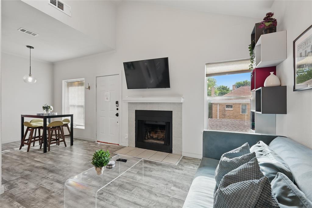 5963 Ross Avenue, Unit 202 Dallas, TX 75206 - Photo 3 of 15 a living room with furniture and a fireplace