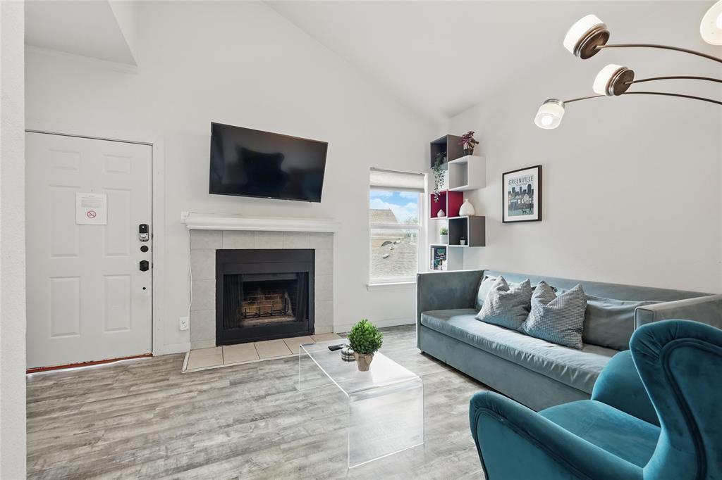 5963 Ross Avenue, Unit 202 Dallas, TX 75206 - Photo 4 of 15 a living room with furniture and a fireplace