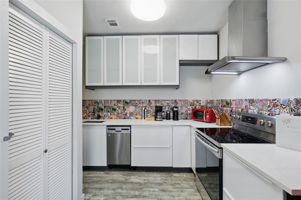 5963 Ross Avenue, Unit 202 Dallas, TX 75206 - Photo 6 of 15 a kitchen with stainless steel appliances granite countertop a sink and cabinets