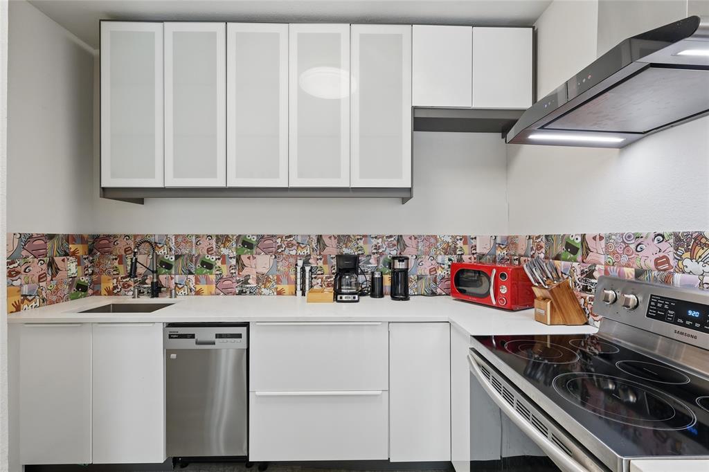 5963 Ross Avenue, Unit 202 Dallas, TX 75206 - Photo 7 of 15 a kitchen with stainless steel appliances granite countertop a sink and cabinets