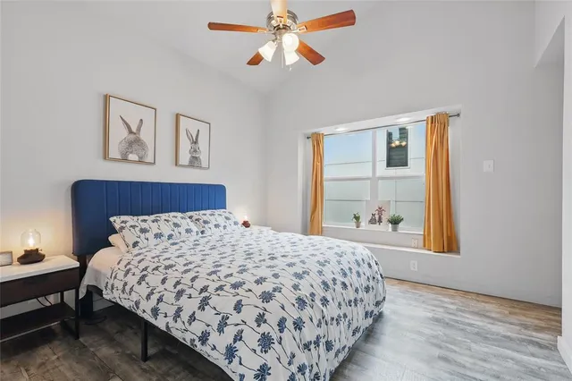 a bedroom with a large bed and a chandelier