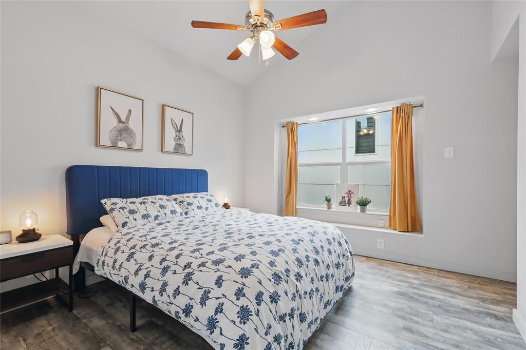 5963 Ross Avenue, Unit 202 Dallas, TX 75206 - Photo 10 of 15 a bedroom with a large bed and a chandelier