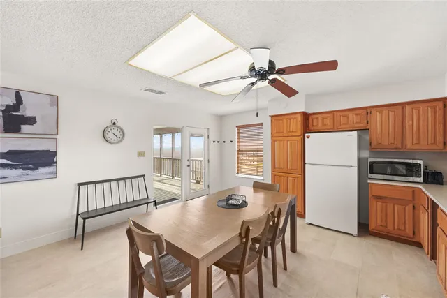 a view of a dining room with furniture and a chandelier