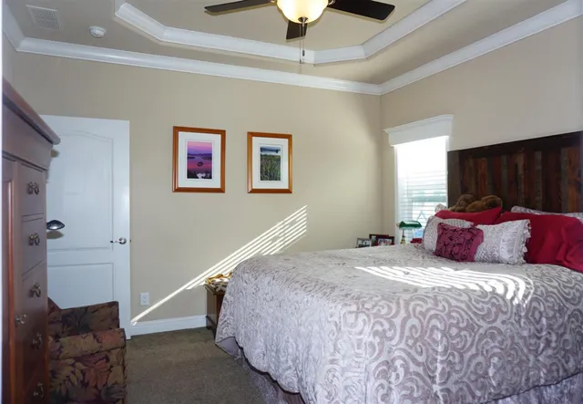 a bedroom with a bed and a chandelier