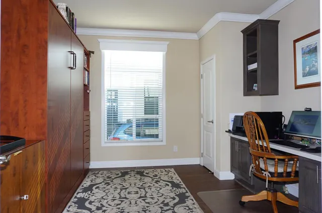 a view of workspace with wooden floor windows