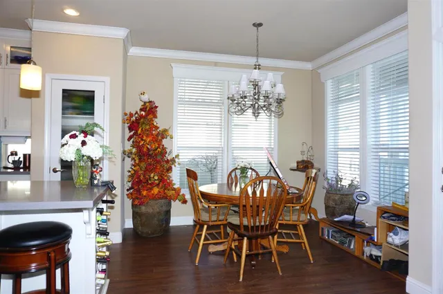 a view of a dining room with furniture and chandelier