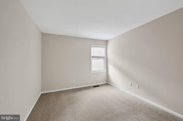 a view of an empty room and a window