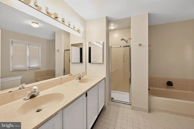 a bathroom with a tub sink double and mirror