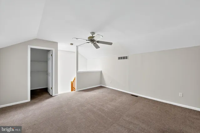 a view of a room with cabinet and a chandelier fan