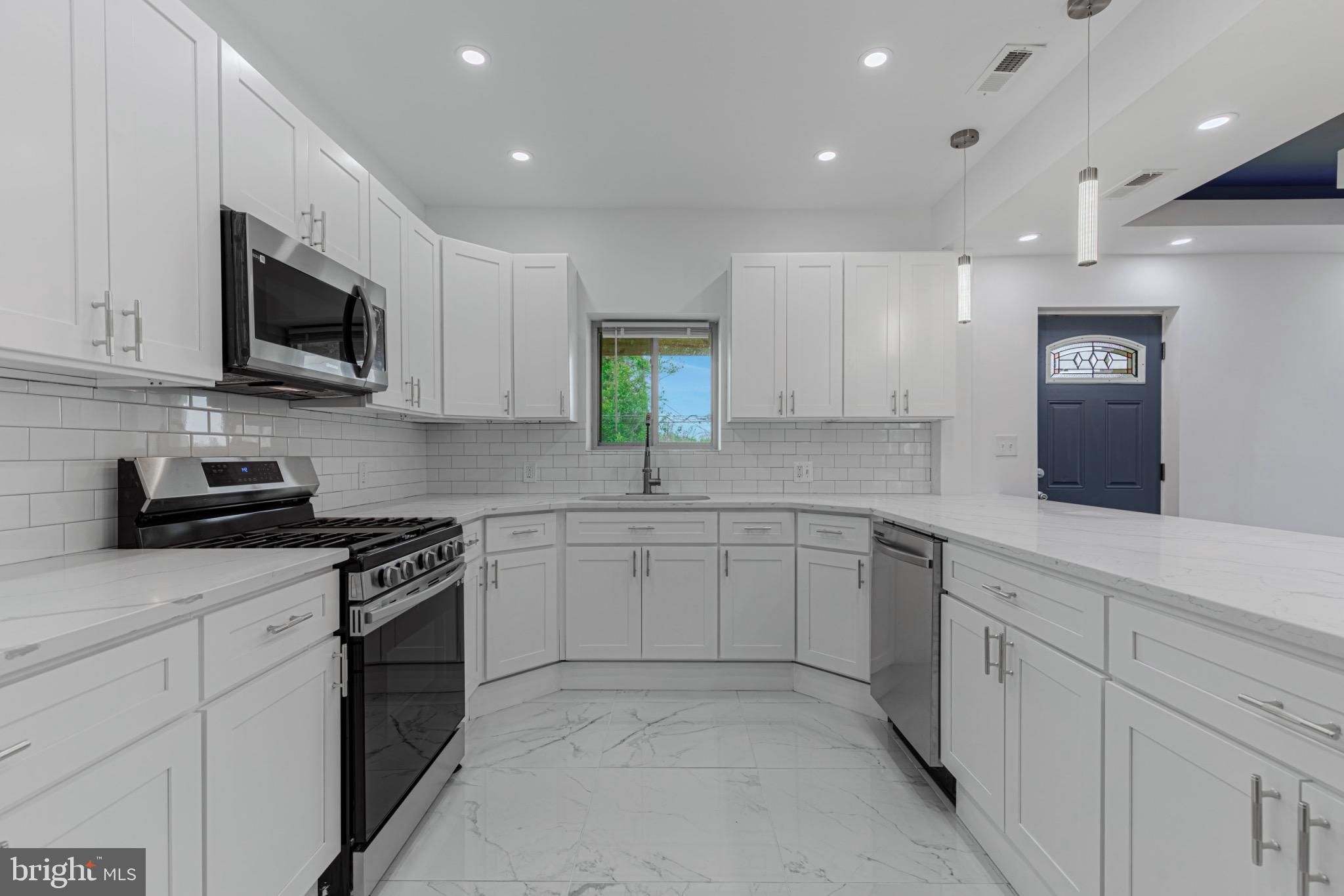 3009 Lyttleton Road Baltimore, MD 21216 - Photo 13 of 34 a kitchen with granite countertop white cabinets stainless steel appliances and a counter space