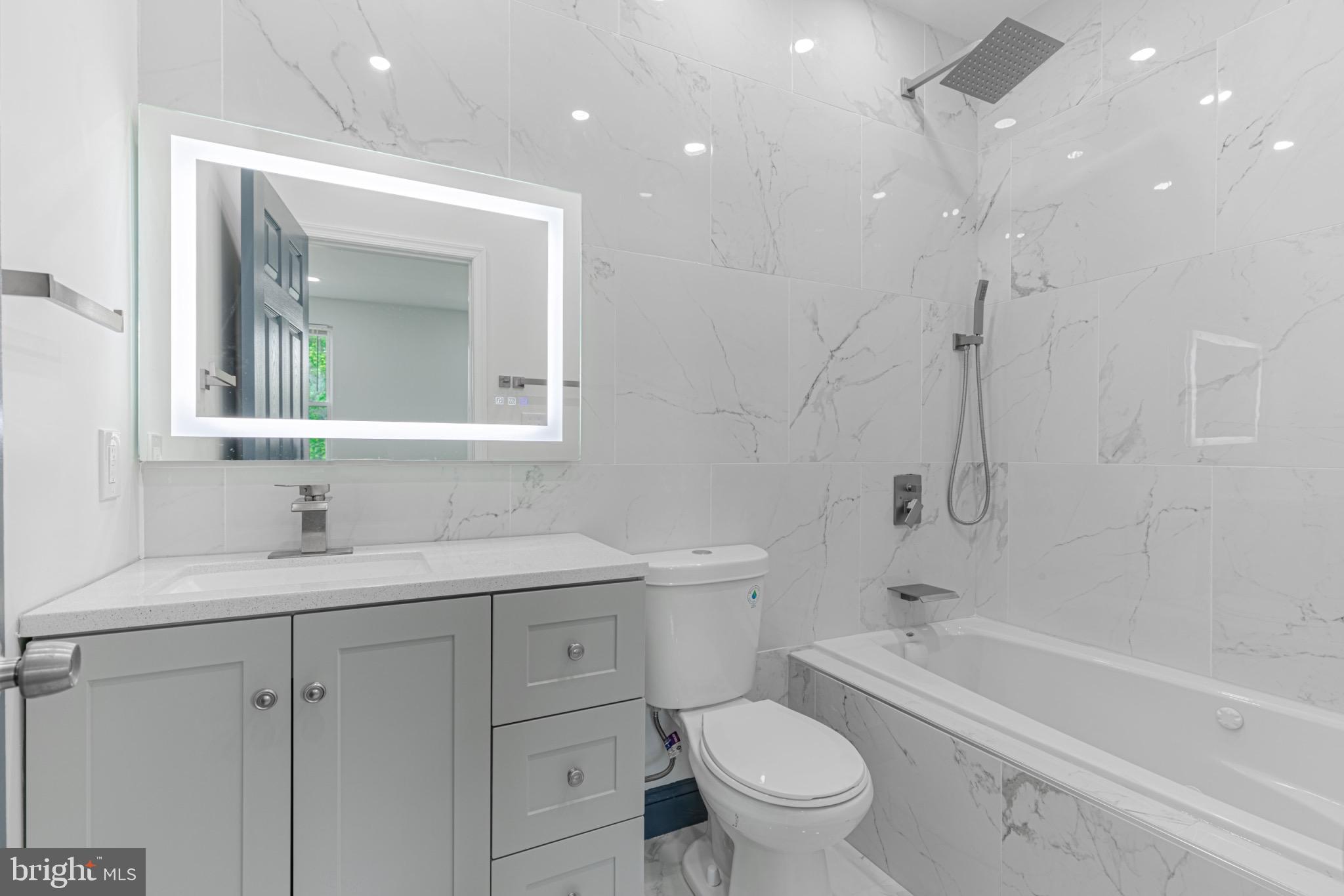 3009 Lyttleton Road Baltimore, MD 21216 - Photo 22 of 34 a bathroom with a toilet a sink a mirror a bathtub and vanity