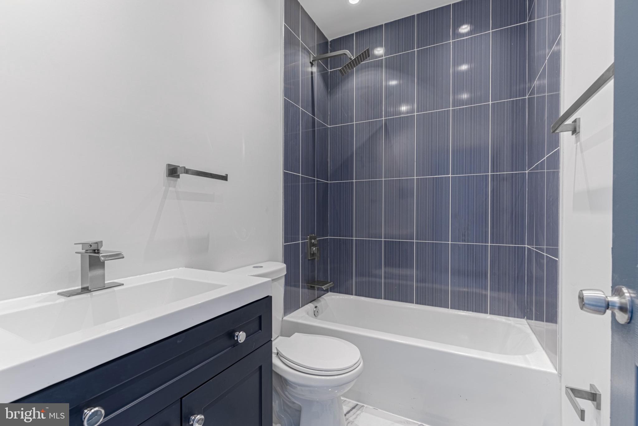 3009 Lyttleton Road Baltimore, MD 21216 - Photo 24 of 34 a bathroom with a sink a toilet and bathtub