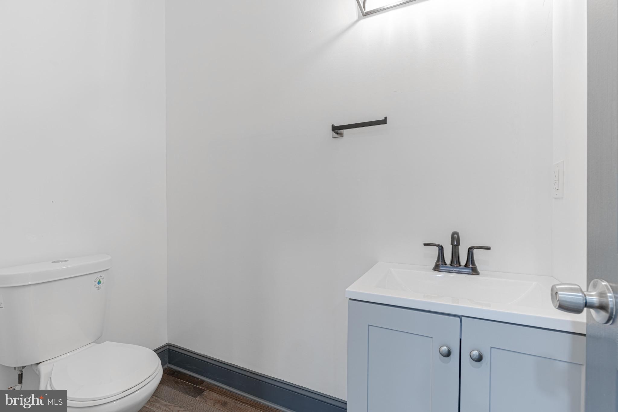3009 Lyttleton Road Baltimore, MD 21216 - Photo 33 of 34 a bathroom with a sink a toilet and a mirror