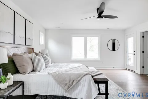 a bedroom with a bed and ceiling fan