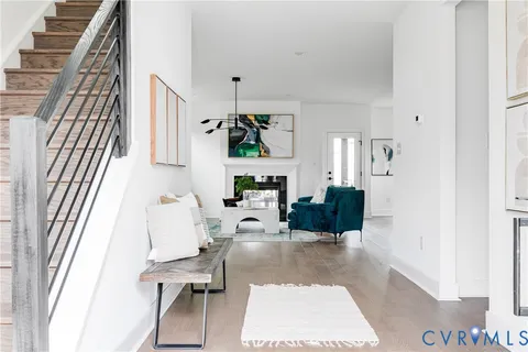a living room with furniture a rug and white walls
