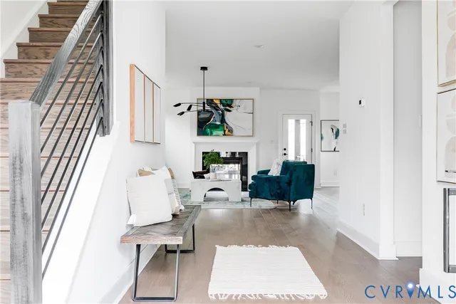 a living room with furniture a rug and white walls