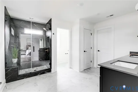 a bathroom with double sink and a mirror