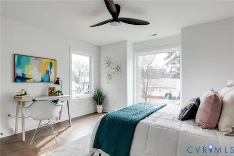 a bedroom with bed and a night stand