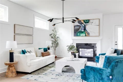 a view of a livingroom with furniture window and wooden floor