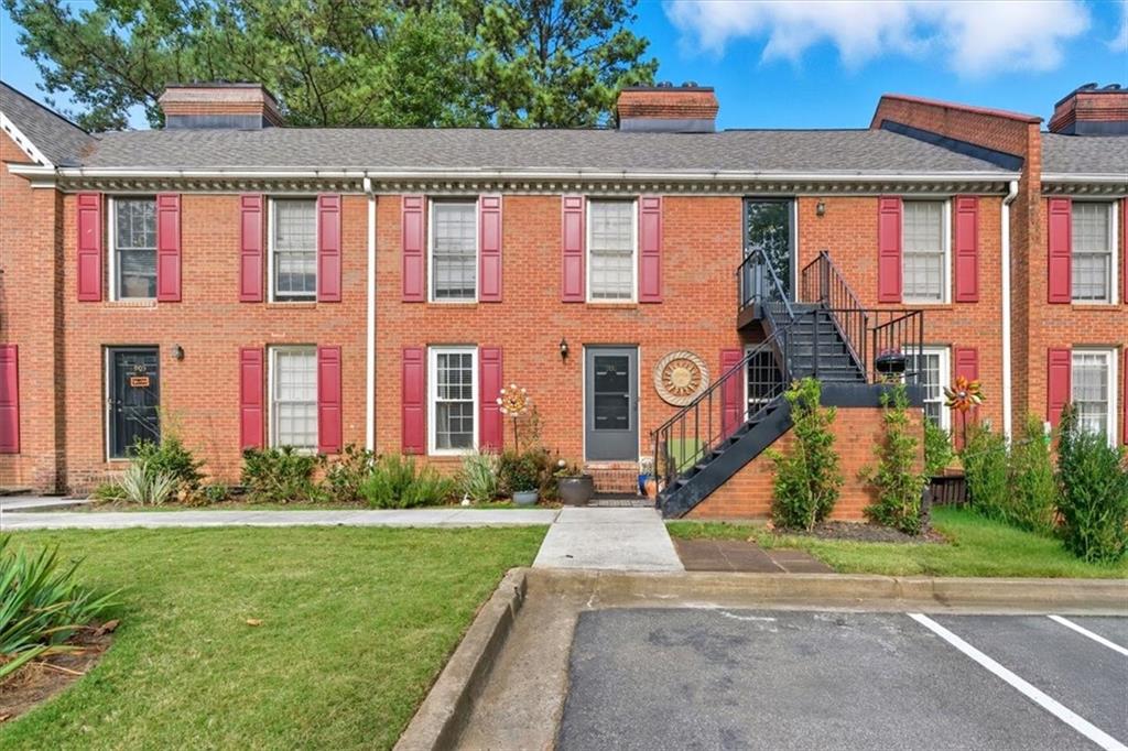 1166 Booth Road Southwest, Unit 906 Marietta, GA 30008 - Photo 1 of 27 front view of house with a yard