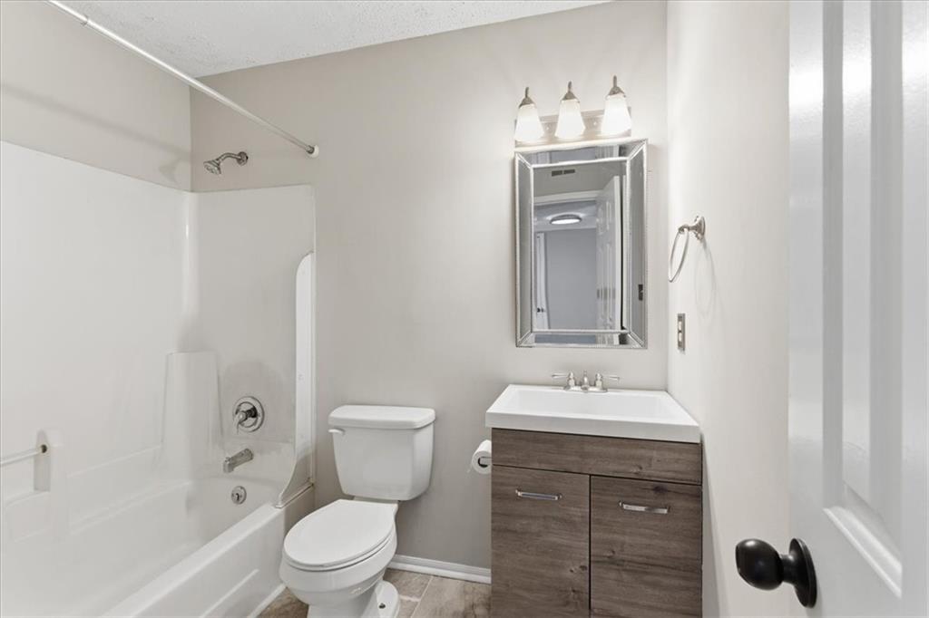 1166 Booth Road Southwest, Unit 906 Marietta, GA 30008 - Photo 12 of 27 a bathroom with a sink toilet and shower