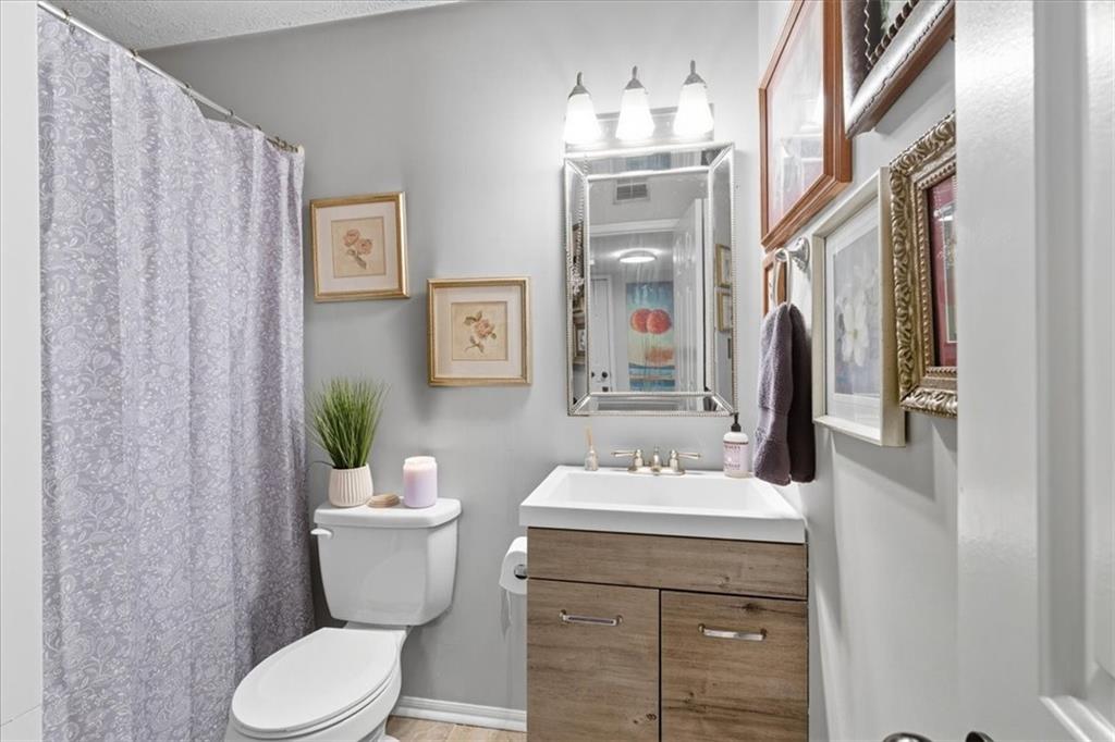 1166 Booth Road Southwest, Unit 906 Marietta, GA 30008 - Photo 13 of 27 a bathroom with a sink toilet and shower