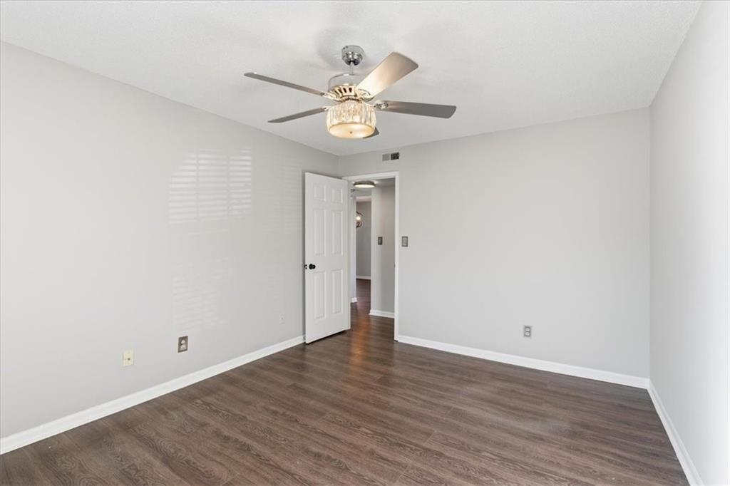 1166 Booth Road Southwest, Unit 906 Marietta, GA 30008 - Photo 15 of 27 a view of an empty room with wooden floor