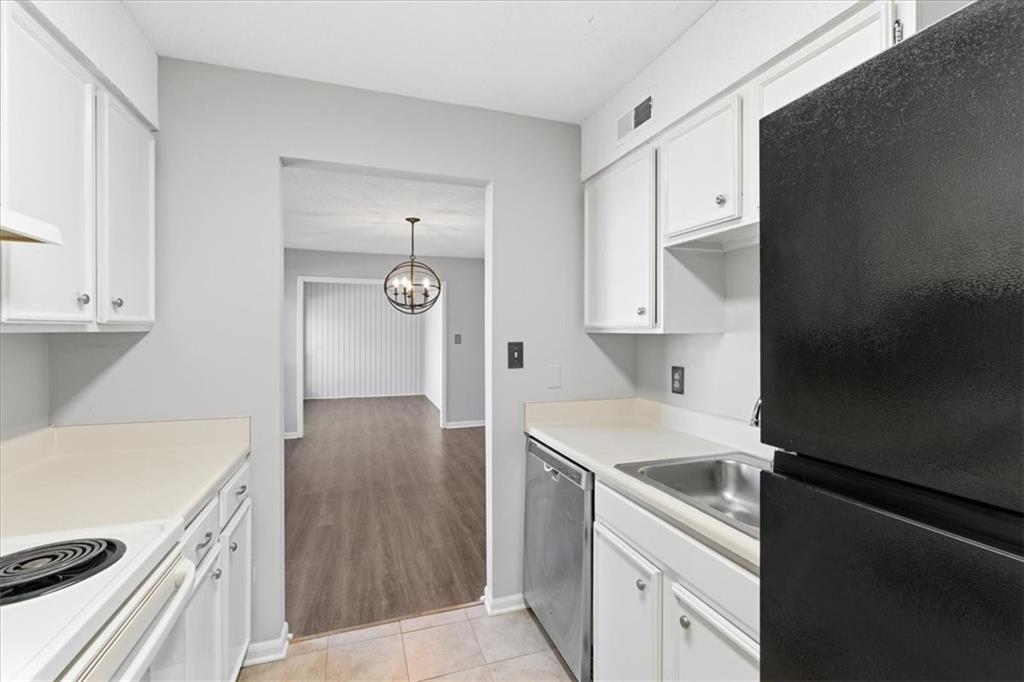 1166 Booth Road Southwest, Unit 906 Marietta, GA 30008 - Photo 23 of 27 a kitchen with a sink stove and cabinets