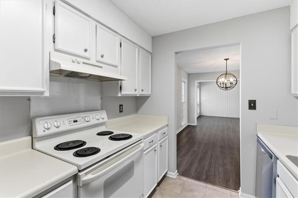 1166 Booth Road Southwest, Unit 906 Marietta, GA 30008 - Photo 24 of 27 a kitchen with appliances cabinets and wooden floor