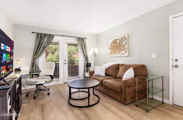 a living room with furniture and a large window