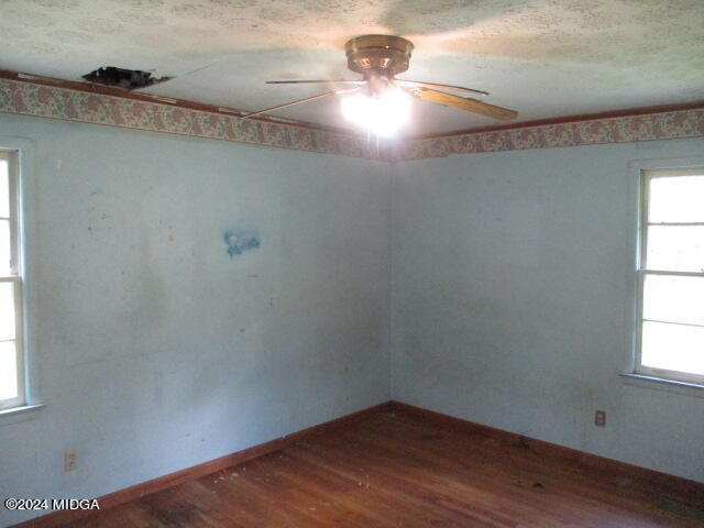 923 Chappell Mill Road Montrose, GA 31065 - Photo 13 of 21 a view of an empty room with wooden floor and a window