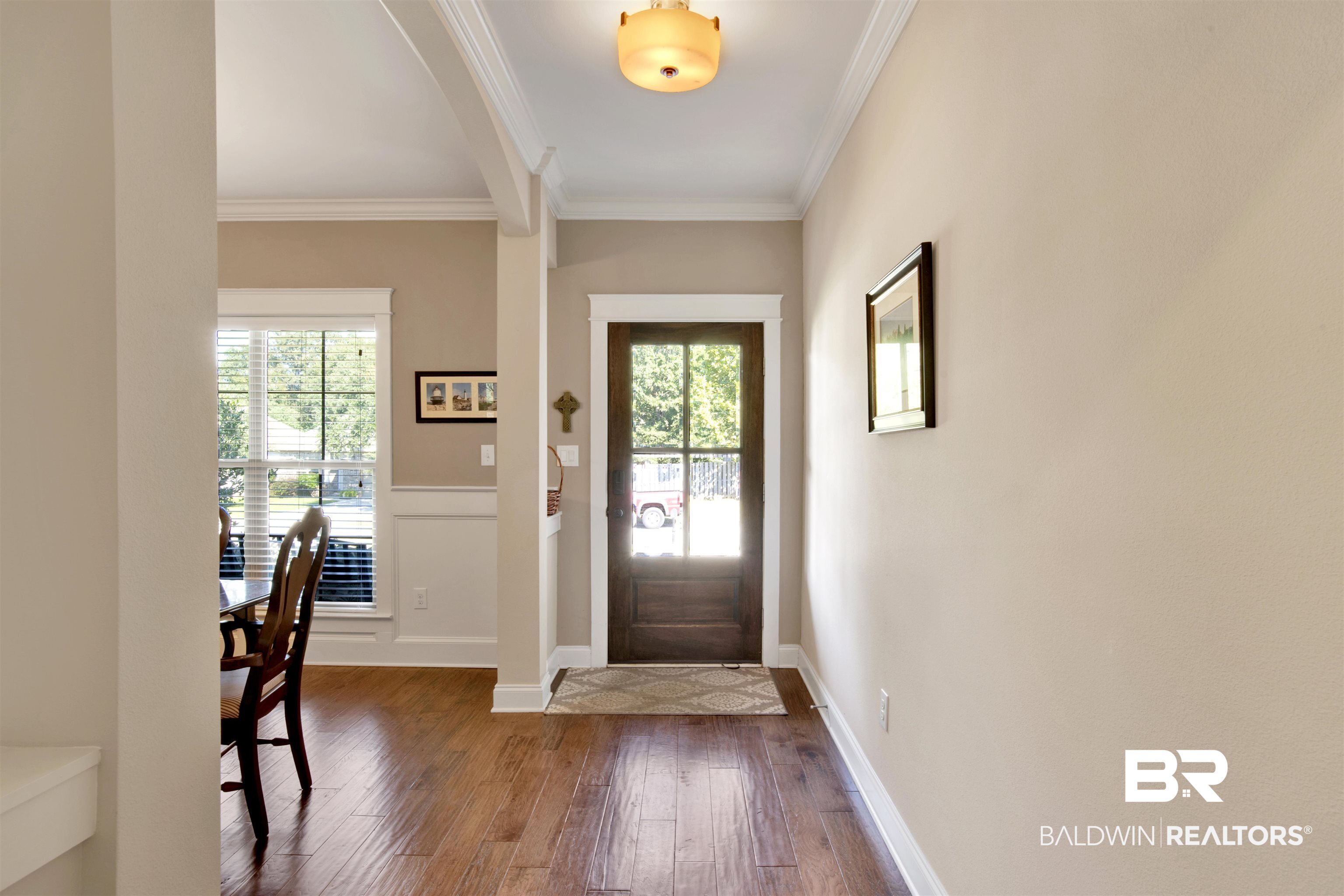 360 Scarlett Avenue Fairhope, AL 36532 - Photo 5 of 34 Entryway featuring a healthy amount of sunlight, crown molding, and dark hardwood / wood-style floors