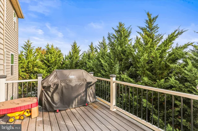 a view of a balcony with wooden floor and fence