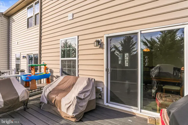 a bedroom with a bed and large windows