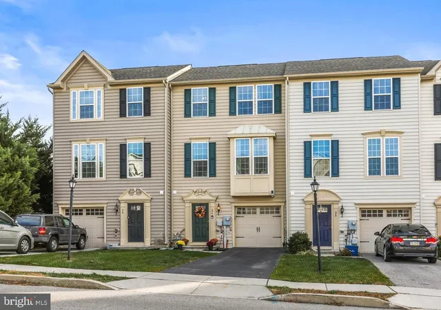 a front view of a residential apartment building with a garden