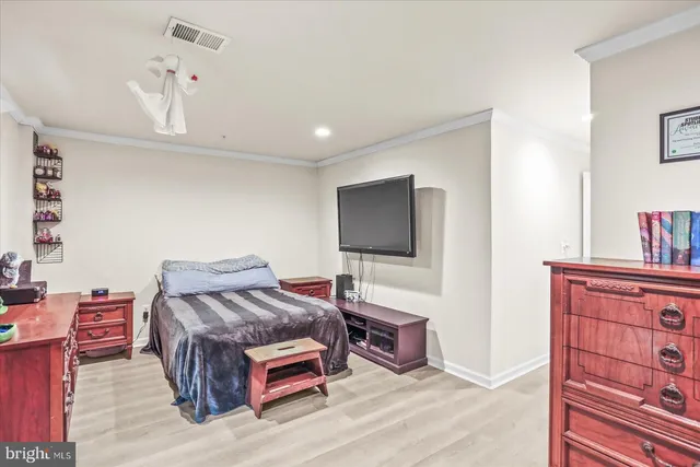 a bedroom with a bed and a dresser