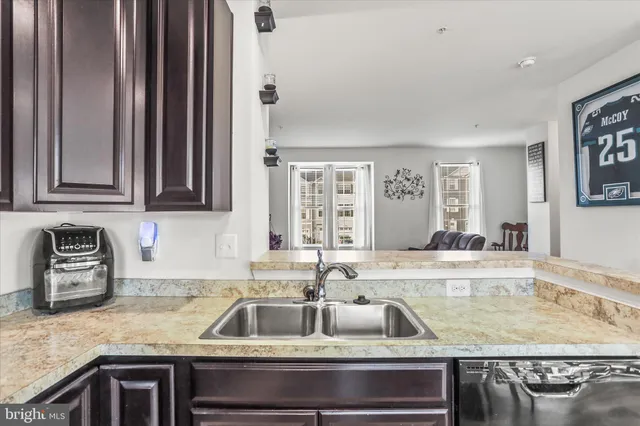 a kitchen with granite countertop a sink and a counter top space