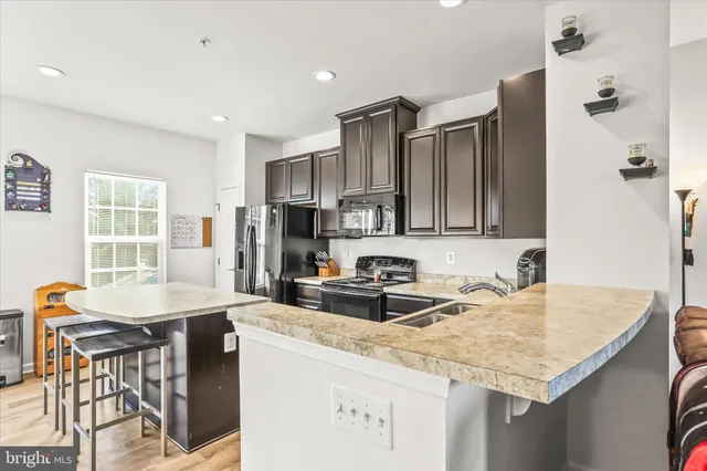 a kitchen with granite countertop a sink and cabinets