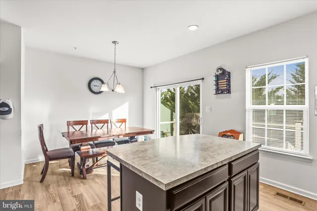 a view of a kitchen with a table and chairs