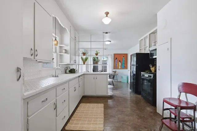 a kitchen with a sink stainless steel appliances and cabinets