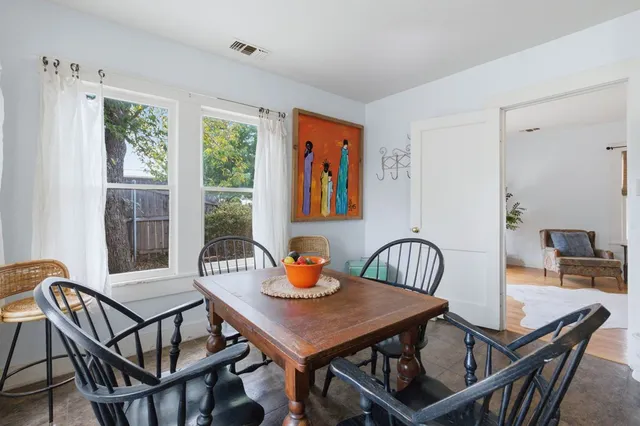 a view of a dining room and livingroom with furniture window and outside view