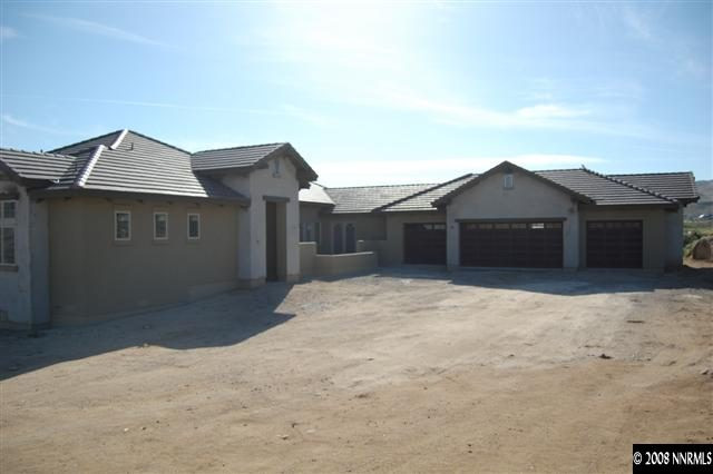 1700 Boulder Ridge Court Reno, NV 89523 - Photo 5 of 9 a front view of a house with a yard and garage