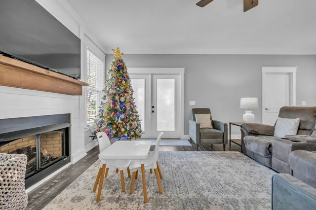 a living room with furniture a flat screen tv and a fireplace