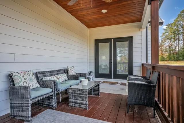 a view of a swimming pool with outdoor seating and a yard