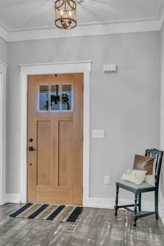 a view of a livingroom with wooden floor and a potted plant