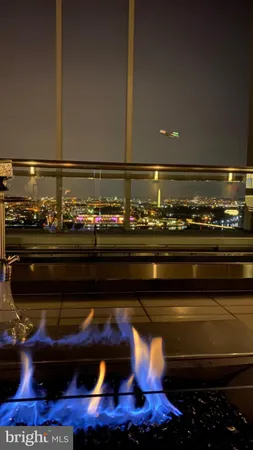 a view of a room with a large window and wooden floor